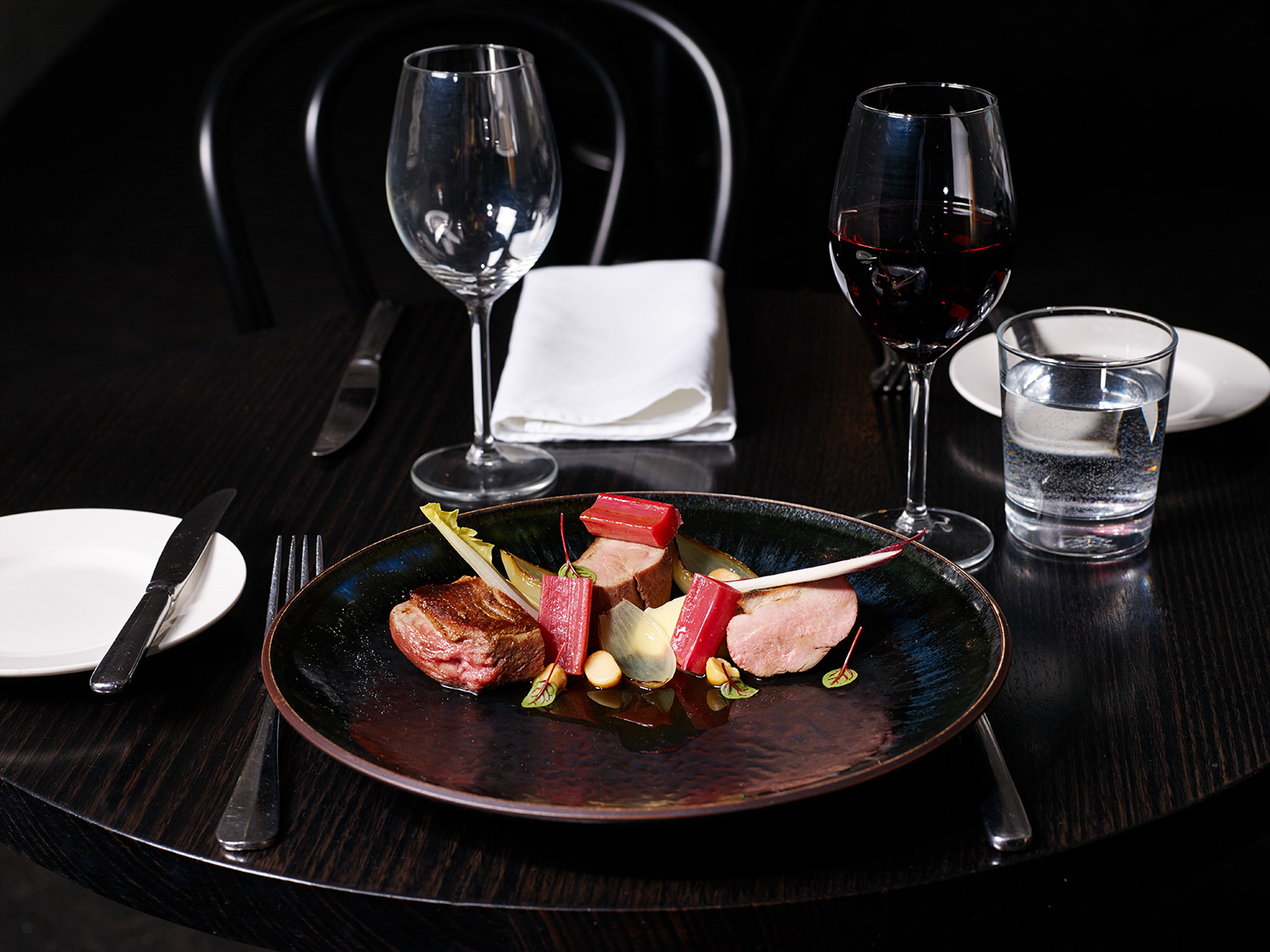Crisp skin duck breast, parsnip purée, poached rhubarb, roasted macadamia nut and baby onion.