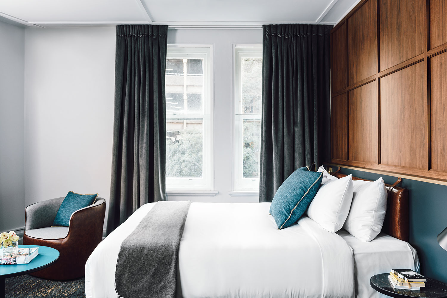 Walnut veneer wall panelling, plush bedding and retro furniture combine to make rooms elegant and appealing