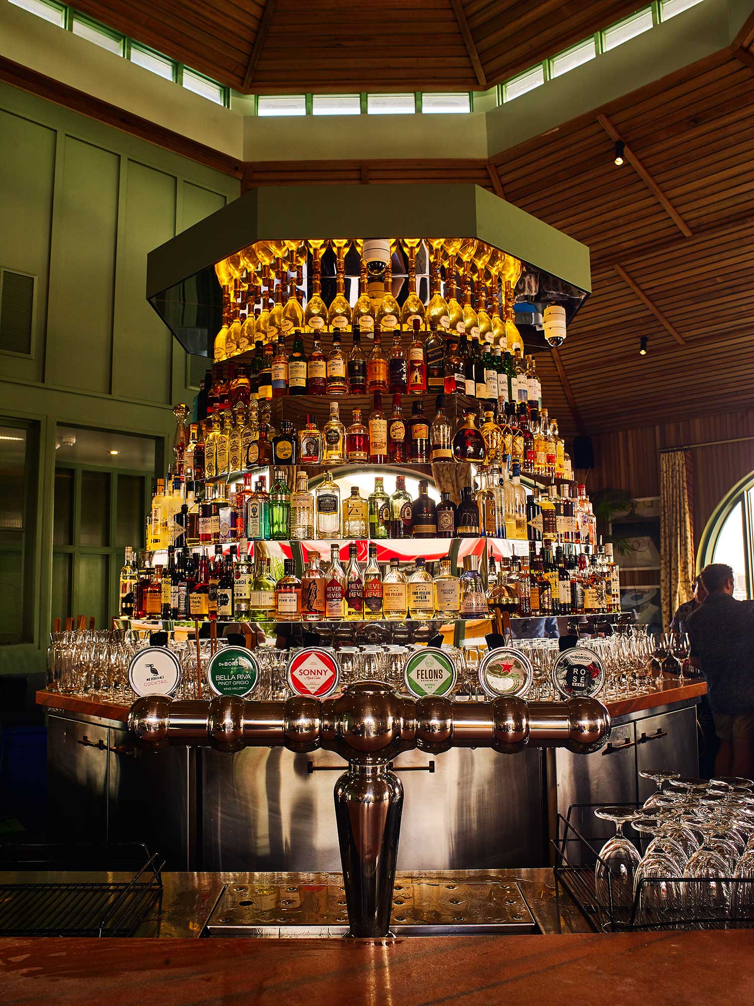 The central cocktail bar at Mr Percival's doubles as a DJ booth, with stairs to the top at its rear.