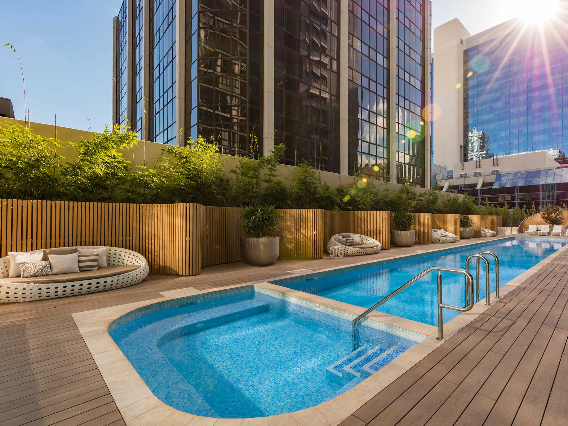 The resort style pool, garden and deck at SKYE Hotel Suites Parramatta