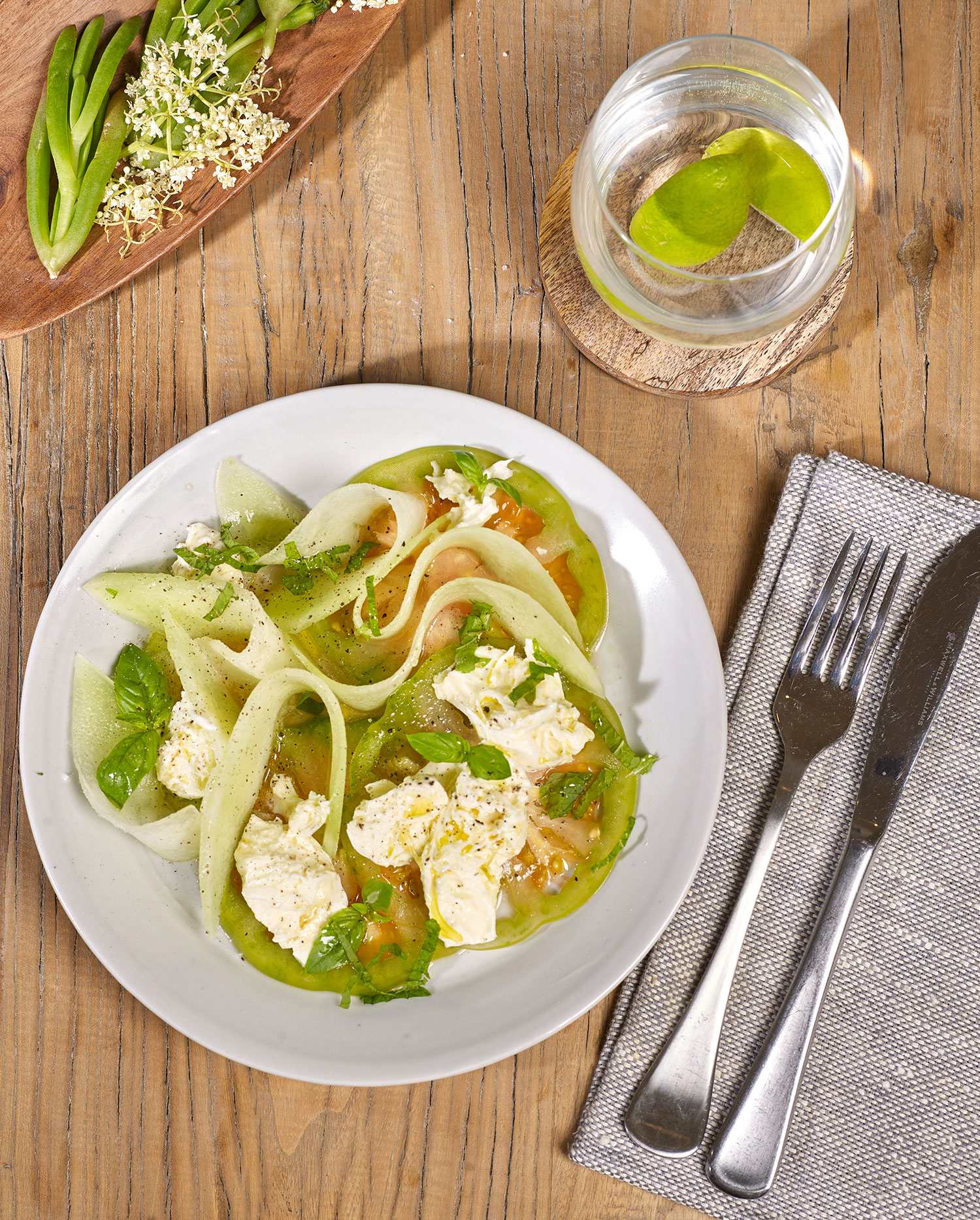 Melon Caprese with green tomato, baby bocconcini, basil and mint