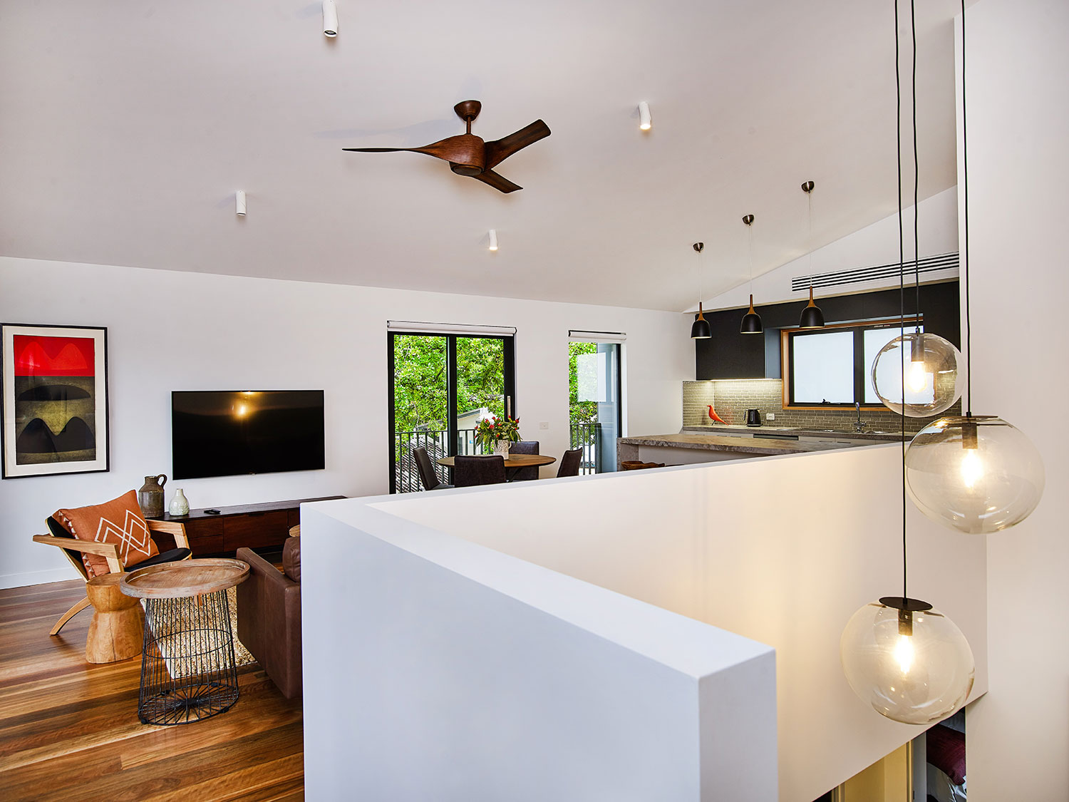 Wide stairwells feature with graduated-fall pendant dome lighting clusters